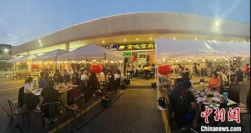 加拿大时间7月18日晚上,大多伦多地区华人聚居区万锦市,一家中餐馆开起了露天大排档,不仅有烧烤啤酒,还有乐队驻场演出。<a target='_blank' data-cke-saved-href='http://www.chinanews.com/' href='http://www.chinanews.com/'>中新社</a>记者 余瑞冬 摄